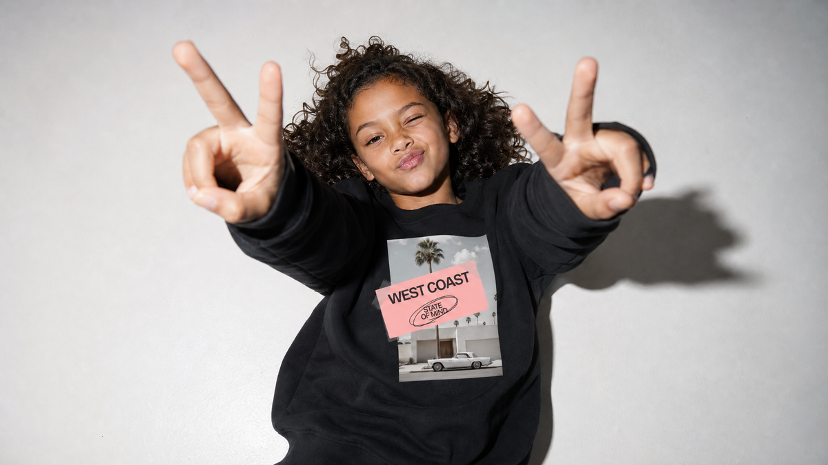 Girl wearing black SAIS graphic sweatshirt from the kids streetwear collection